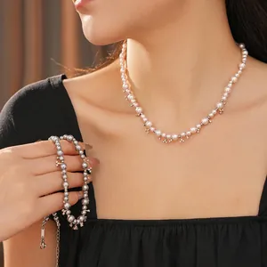 Elegant zircon pearl beaded necklace with silver cross star charms on female model
