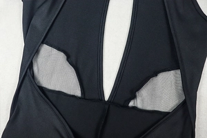Detail of black sports bodysuit showing mesh splicing and high-quality seam work