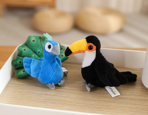 Detailed view of plush peacock and toucan bird toys with soft colorful feathers