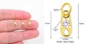 Macro view of a gold-plated copper safety pin pendant with dimensions and weight data