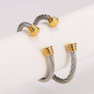Twisted cable cuff bracelet in two-tone gold and silver stainless steel minimalist style
