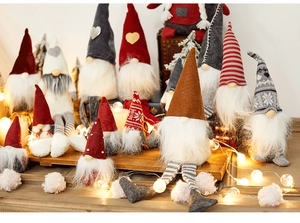 Close-up of assorted handmade Christmas gnomes with plush hats and long faux fur beards