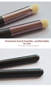 Detail of round silicone lip brush with rose gold ferrule and charcoal grey handle