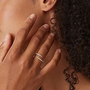 Close-up of minimalist golden S925 silver cross open ring worn on finger