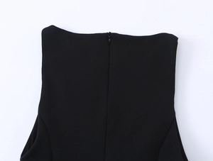 Close-up of the smooth black dress fabric featuring a functional invisible back zipper