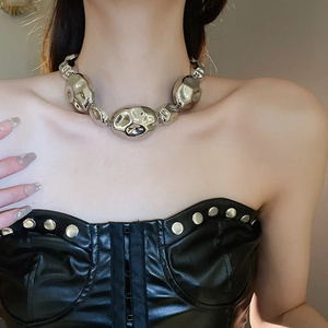 Close-up of chunky silver oval link necklace on model with black leather outfit