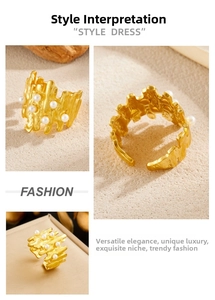 Detail of gold plated stainless steel ring with irregular texture and pearl accents