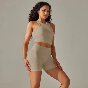 Detail of seamless ribbed knit fabric on women's khaki yoga bra and high-waist shorts set