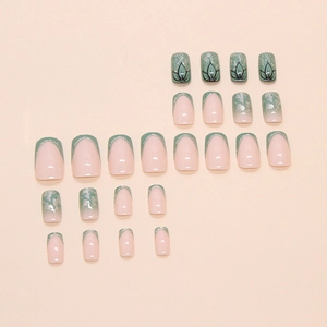Bamboo green press-on nails with French tips, silver glitter, and floral line art designs