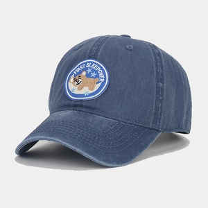 Detailed view of vintage washed blue baseball cap with embroidered bear patch badge