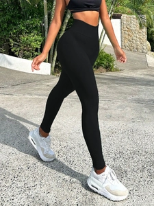 Outdoor shot of high-waist black ribbed yoga leggings showing seamless texture and fit
