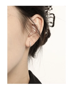 Close-up of minimalist S925 sterling silver hoop earrings worn by a model
