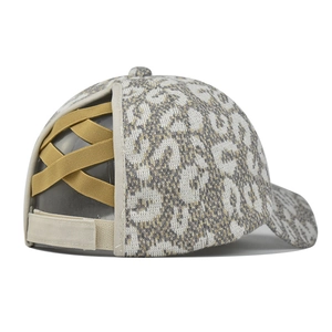 Macro view of leopard knit ponytail beanie hat with elastic criss-cross back opening