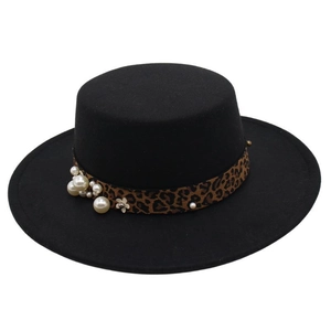 Detail of black felt hat featuring a leopard print ribbon band with pearls and floral accent