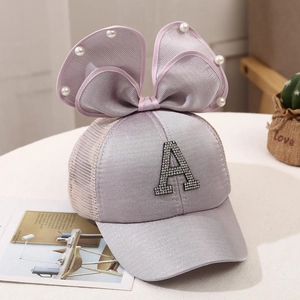 Detail of lavender mesh sun hat with pearl bow and sparkling rhinestone letter A