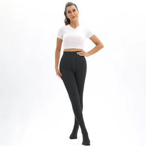 Close-up of black high-waisted thermal leggings with tummy control and elastic slim fit