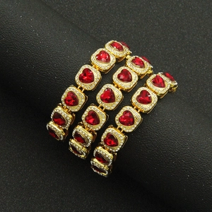 Hip hop style gold bracelet set with red heart gems and sparkling rhinestones