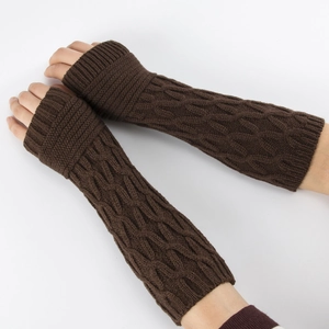 Detailed close-up of dark brown cable-knit fingerless gloves showing knit texture