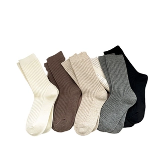 Five pairs of ribbed cotton blend crew socks in classic neutral colors for autumn