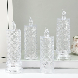 Detailed view of four clear acrylic LED candle lights with diamond-cut crystal patterns
