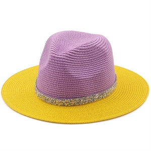 Two-tone purple and yellow straw Fedora hat with sparkling sequin band on white background