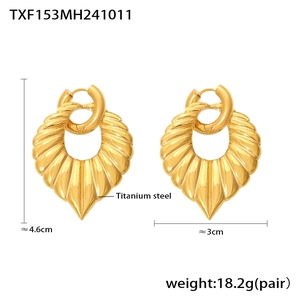Detail view of 18k gold plated titanium steel leaf earrings with rippled texture