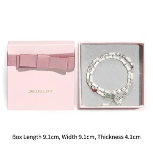 Beaded bracelet with butterfly charm in a 9.1cm pink jewelry gift box detail