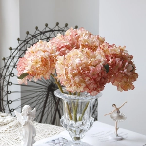 Pink faux hydrangea in an embossed glass vase with vintage decor for home styling