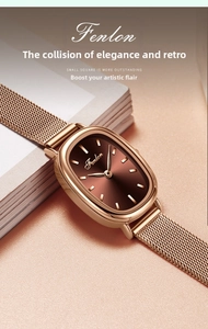 Detail of rose gold oval watch with brown sunray dial and mesh bracelet on a soft background