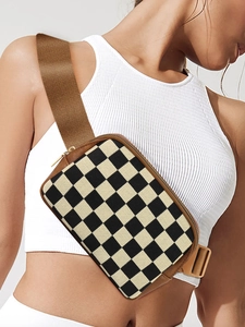 Macro detail of checkered nylon belt bag with leather trim and gold hardware