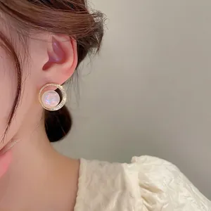 French gold plated mermaid pearl hoop earrings with zircon accents on Asian model