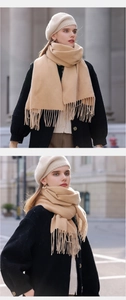 Detail shot of a beige tassel scarf and beret set made of soft cashmere-like fabric