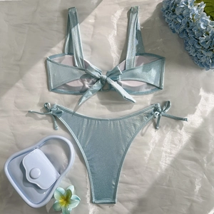Flat lay of light blue glitter bikini with back bow ties and matching side-tie bottoms