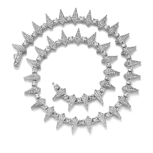 Detailed view of silver hiphop cuban link chain with spiked charms and clear rhinestones