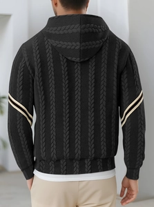 Detail of black textured knit hoodie showing sleeve stripes and premium cable knit pattern