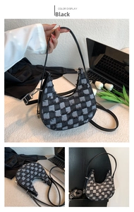 Detail of black tweed crescent bag featuring frayed edges and stylish plaid patterns
