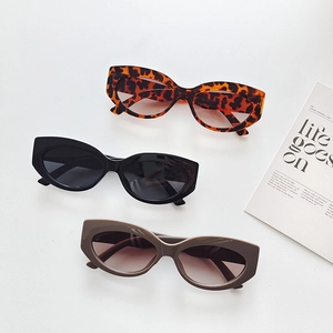 Three pairs of modern retro round frame cat eye sunglasses in leopard, black, and taupe