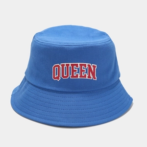 Detail of blue cotton bucket hat featuring red QUEEN embroidery with white borders
