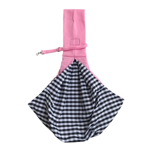 Detail view of pink pet carrier bag with black-and-white plaid lining and safety hook