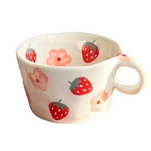 Hand-painted ceramic mug with red strawberries and pink flowers on cream background
