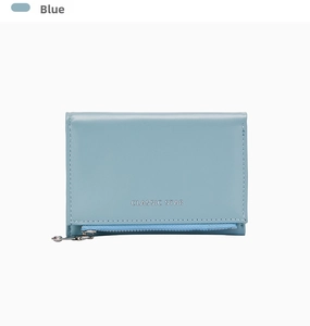 Detail view of light blue leather wallet featuring silver Classic Star logo and zip pocket