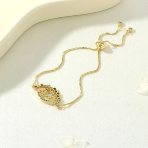 Detail view of gold MAMA bracelet with colorful zircons and adjustable box chain