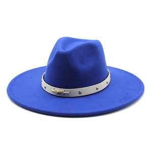 Close-up of royal blue wool fedora hat with beige leather strap and metal rivet accents