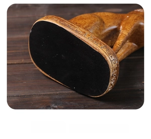 Detail of resin Egyptian cat base with wood-grain finish and non-slip bottom pad