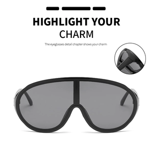 Macro view showing the polished black frame texture and thick temple of the Y2K shield sunglasses