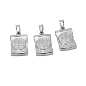 Detailed macro view of polished stainless steel St. Benedict cross pendant with engravings