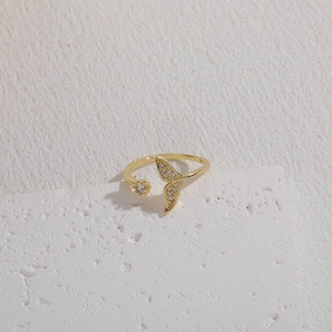 Macro detail of golden mermaid tail ring with glittering cubic zirconia stones