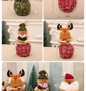 Detail of Christmas drawstring gift bags featuring 3D Santa, snowman, and reindeer designs