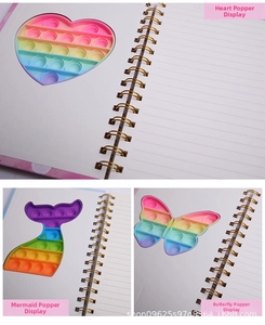 Detail view of A5 spiral notebooks with rainbow silicone pop-it sensory fidget covers