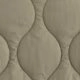 Close-up of khaki wavy quilted fabric texture with fine stitching on long sleeve jacket